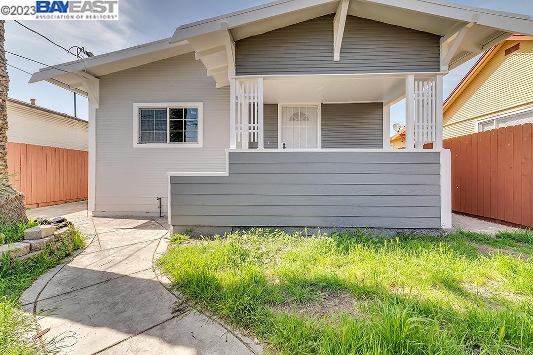 1321 60th Avenue Oakland, CA 94621 - Photo 1 of 41 a front view of a house with a garden