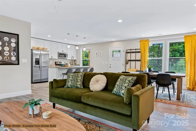 a kitchen with stainless steel appliances kitchen island granite countertop a dining table chairs and granite counter tops