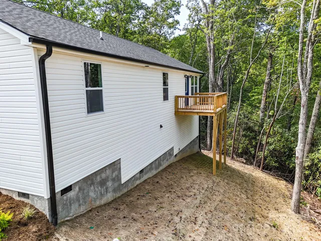 a view of a house with a small yard and wooden fence