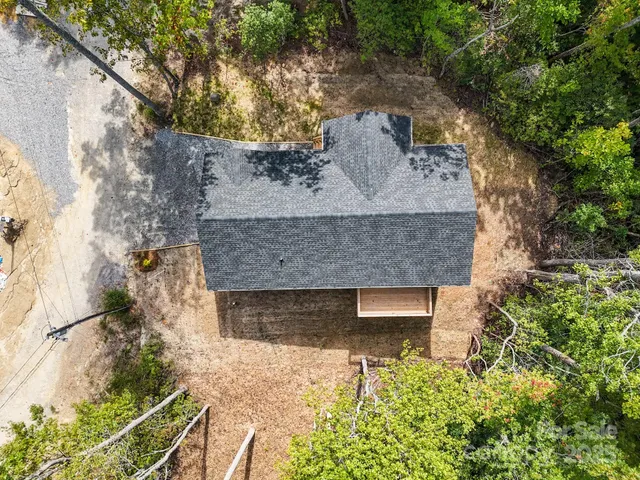 an aerial view of a house with yard and outdoor seating