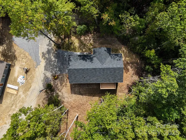 a kitchen with kitchen island granite countertop a refrigerator and microwave