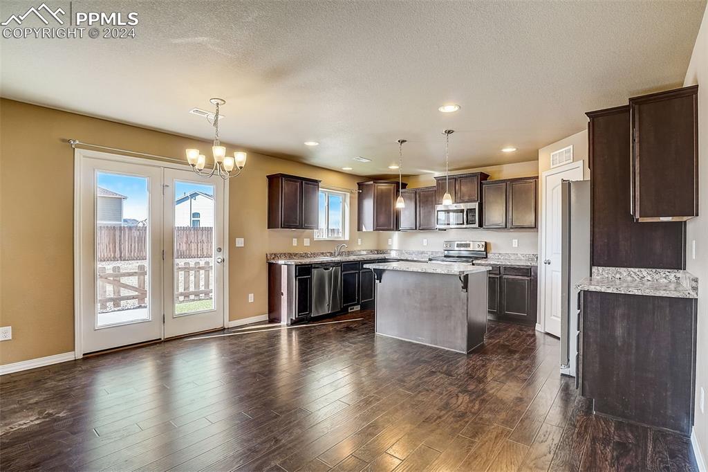 11642 Avena Road Peyton, CO 80831 - Photo 11 of 50 a large kitchen with a large window and stainless steel appliances
