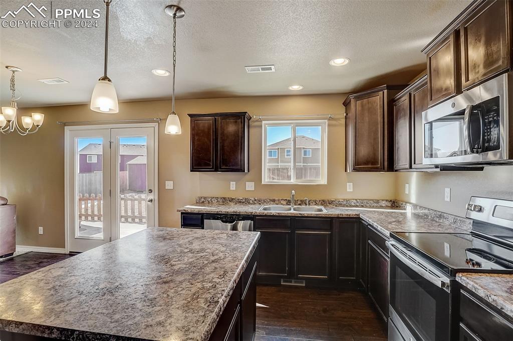 11642 Avena Road Peyton, CO 80831 - Photo 15 of 50 a kitchen with lots of counter space and a sink