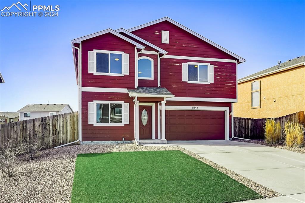 11642 Avena Road Peyton, CO 80831 - Photo 2 of 50 a front view of a house with a yard