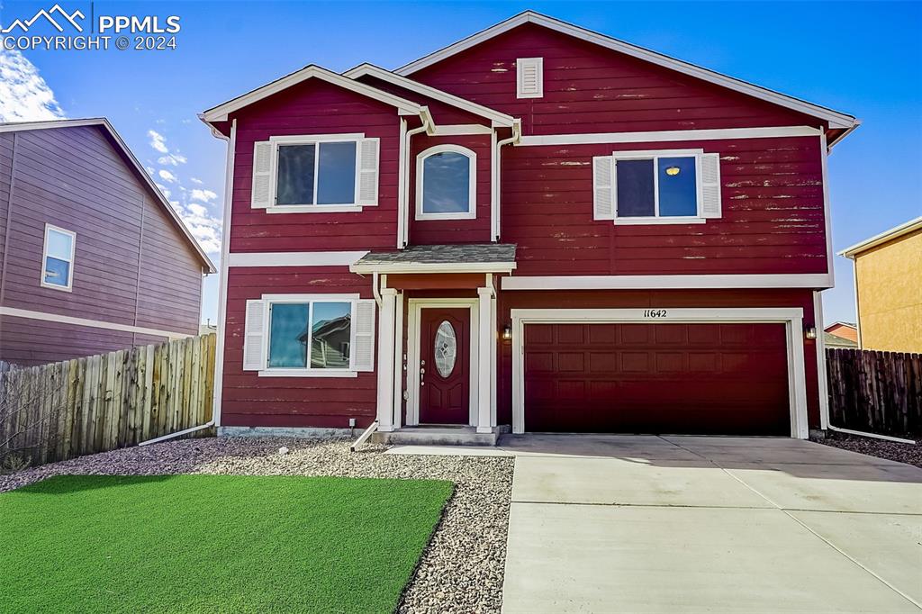 11642 Avena Road Peyton, CO 80831 - Photo 3 of 50 a front view of a house with garden