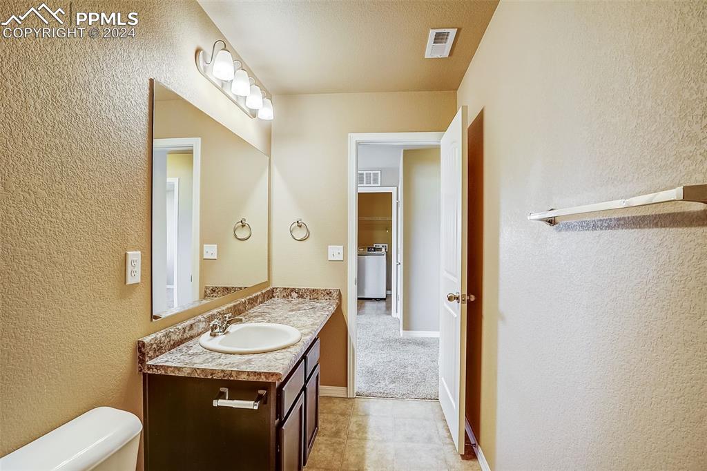 11642 Avena Road Peyton, CO 80831 - Photo 35 of 50 a bathroom with a sink a toilet and shower