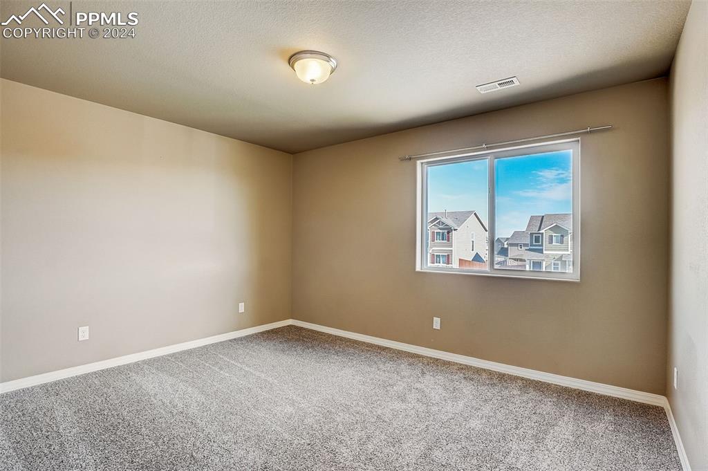 11642 Avena Road Peyton, CO 80831 - Photo 36 of 50 an empty room with painting on the wall