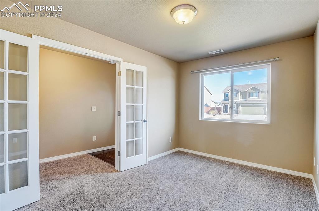 11642 Avena Road Peyton, CO 80831 - Photo 6 of 50 an empty room with windows and closet