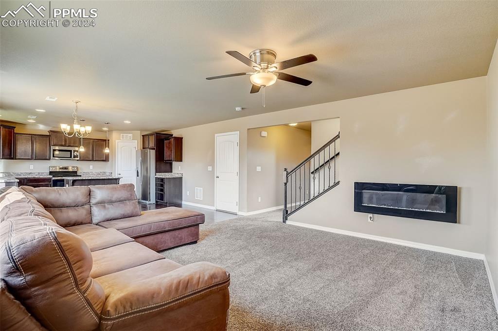 11642 Avena Road Peyton, CO 80831 - Photo 9 of 50 a living room with furniture and kitchen view