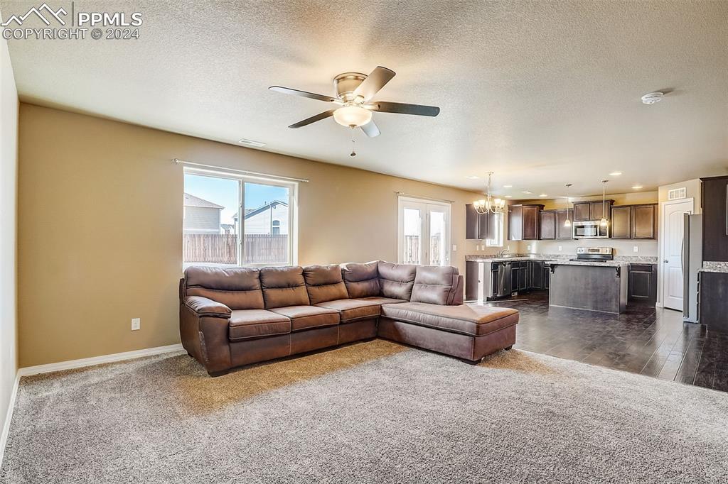 11642 Avena Road Peyton, CO 80831 - Photo 10 of 50 a living room with furniture and kitchen view