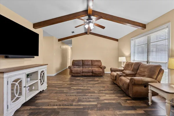 a living room with furniture and a flat screen tv