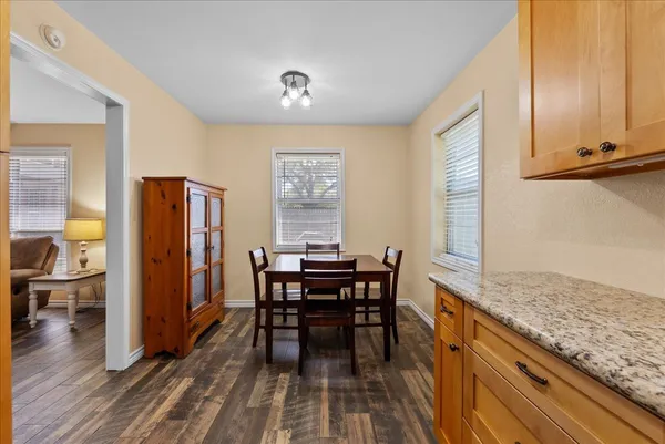 a view of a dining room with furniture and wooden floor
