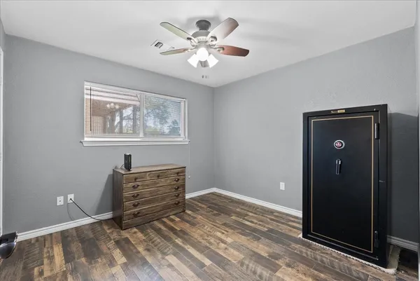 a view of an empty room with window and cabinet
