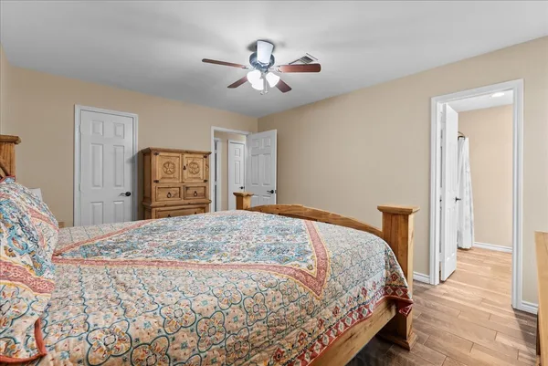 a bedroom with a bed and a chandelier