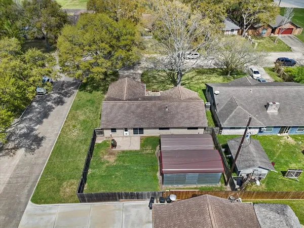an aerial view of a house with a yard