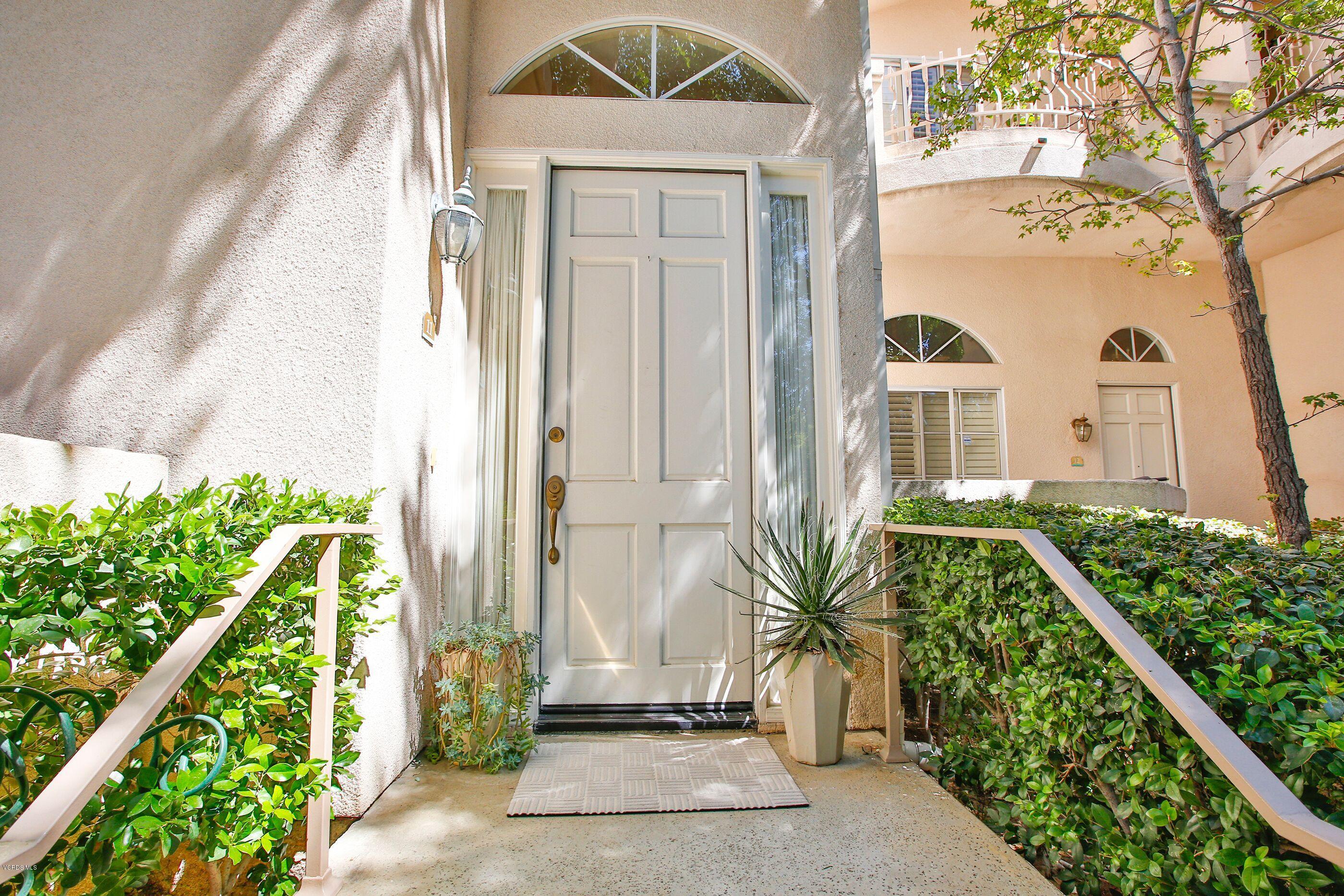 5340 Las Virgenes Road, Unit 11 Calabasas, CA 91302 - Photo 2 of 19 a front view of a house with a yard