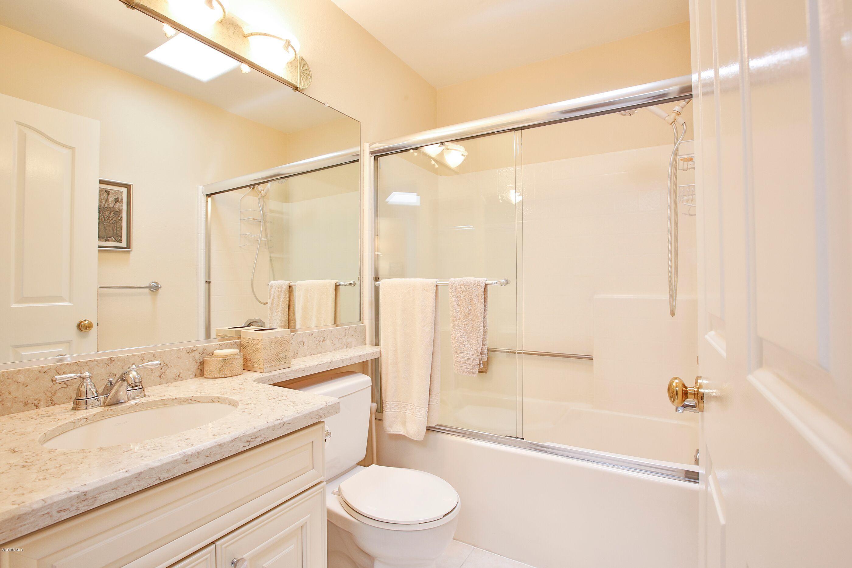5340 Las Virgenes Road, Unit 11 Calabasas, CA 91302 - Photo 12 of 19 a bathroom with a granite countertop sink toilet and shower