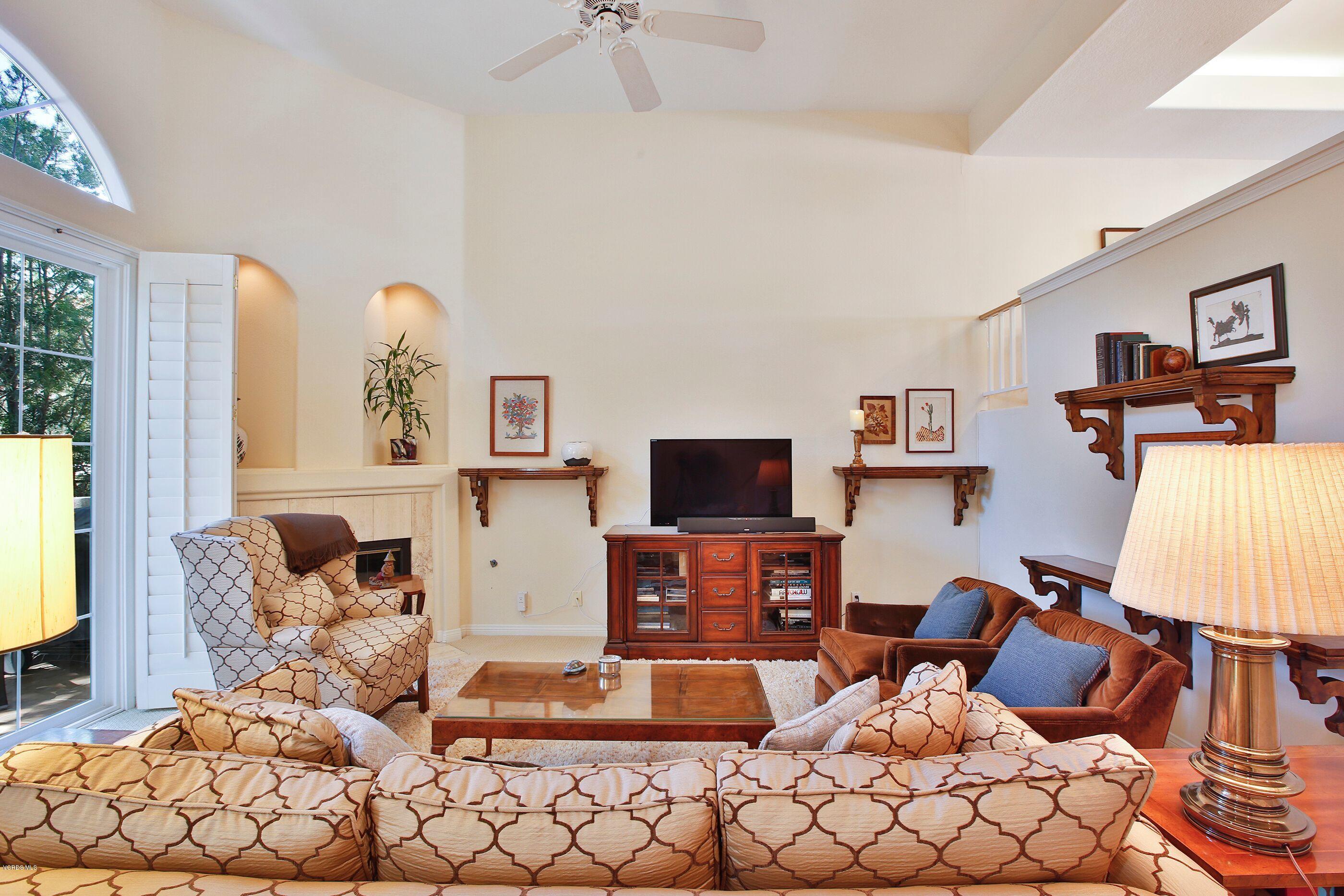 5340 Las Virgenes Road, Unit 11 Calabasas, CA 91302 - Photo 3 of 19 a living room with furniture a flat screen tv and a fireplace