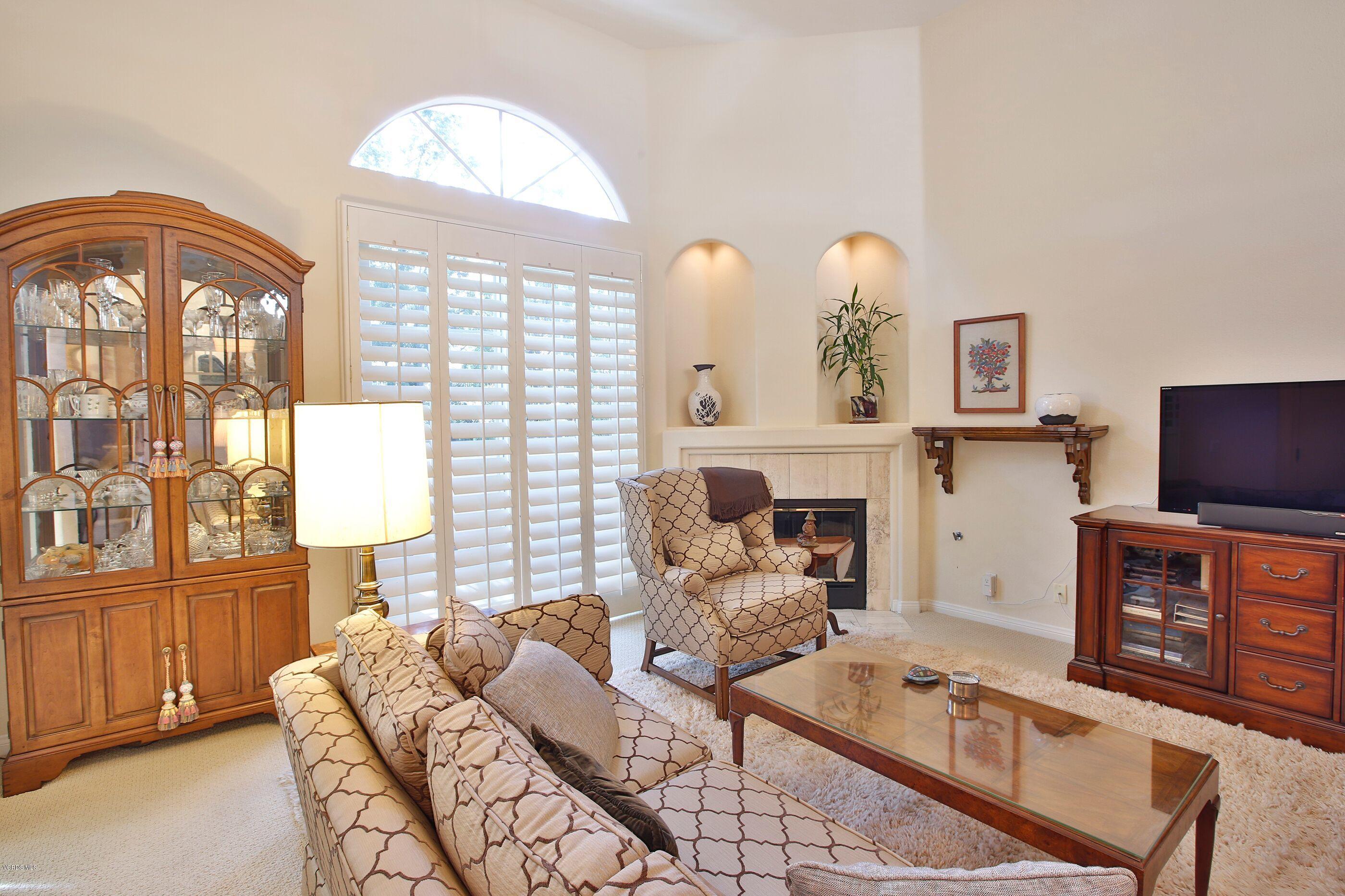 5340 Las Virgenes Road, Unit 11 Calabasas, CA 91302 - Photo 4 of 19 a living room with furniture a fireplace and a flat screen tv