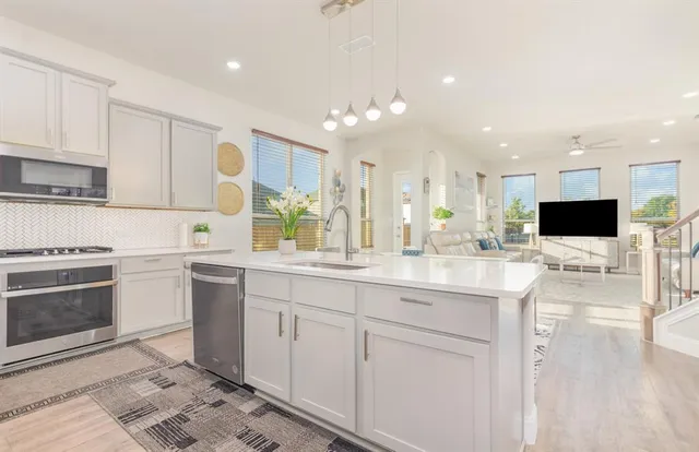 an aerial view of residential houses with outdoor space and swimming pool