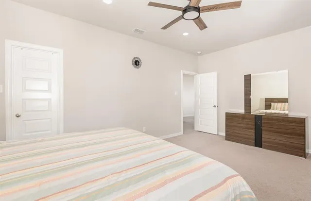 a bedroom with a bed and painting on the wall