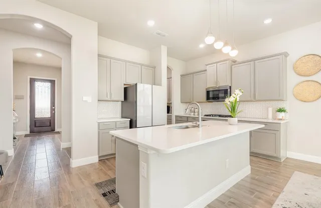 a kitchen with refrigerator and cabinets