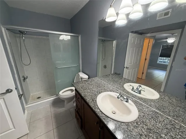 a view of an empty room with a chandelier