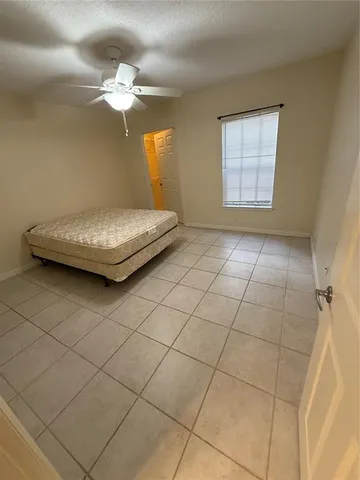 a kitchen with granite countertop a sink a stove and cabinets
