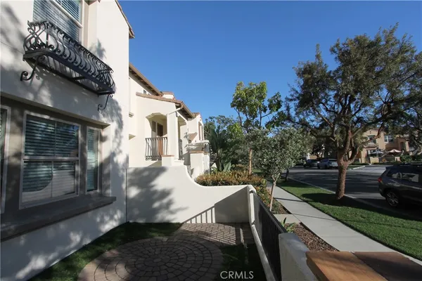 a view of a patio with table and chairs and potted plants with wooden fence