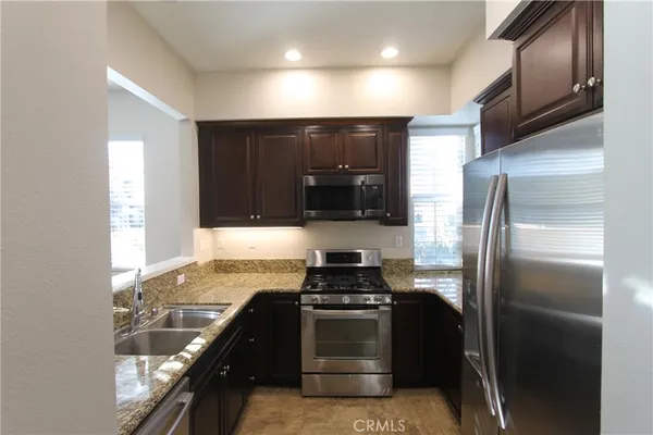 a kitchen with a refrigerator and a stove