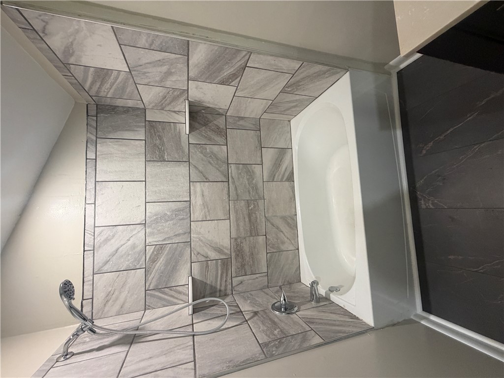 221 Richey Street Anderson, SC 29625 - Photo 19 of 22 The mother-in-law suite bathroom features a contemporary shower and tub, offering both style and practical design.