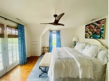 a bedroom with a bed and a painting on the wall