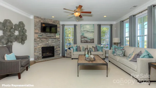 a living room with furniture a large window and a fireplace