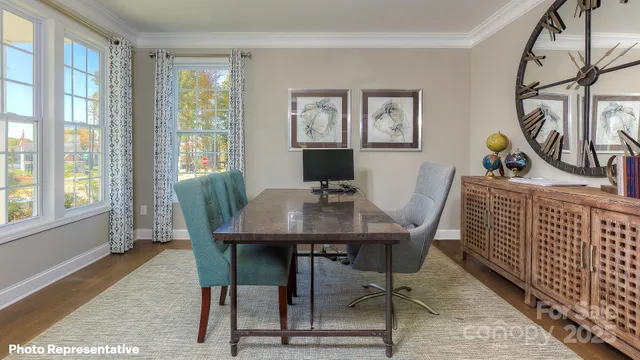 a view of a dining room with furniture window and wooden floor