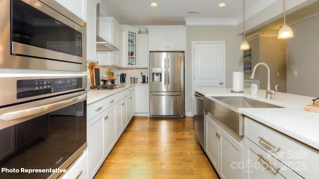 a kitchen with stainless steel appliances a sink stove and refrigerator