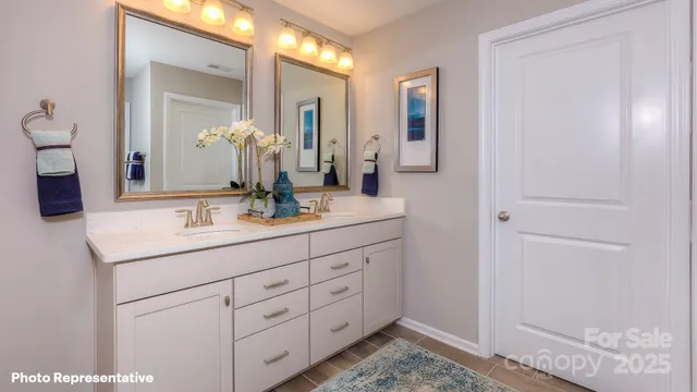 a bathroom with a double vanity sink and a mirror