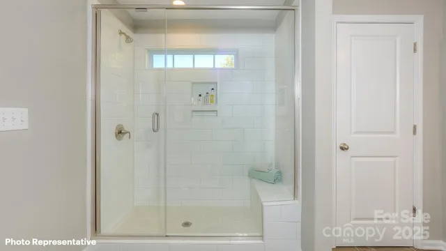 a bathroom with a glass shower door