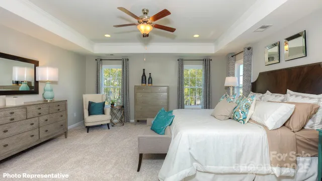 a bedroom with a bed a couch and furniture