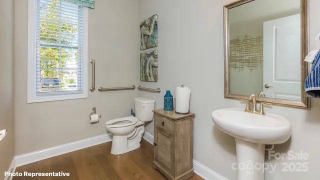a bathroom with a sink toilet and a mirror