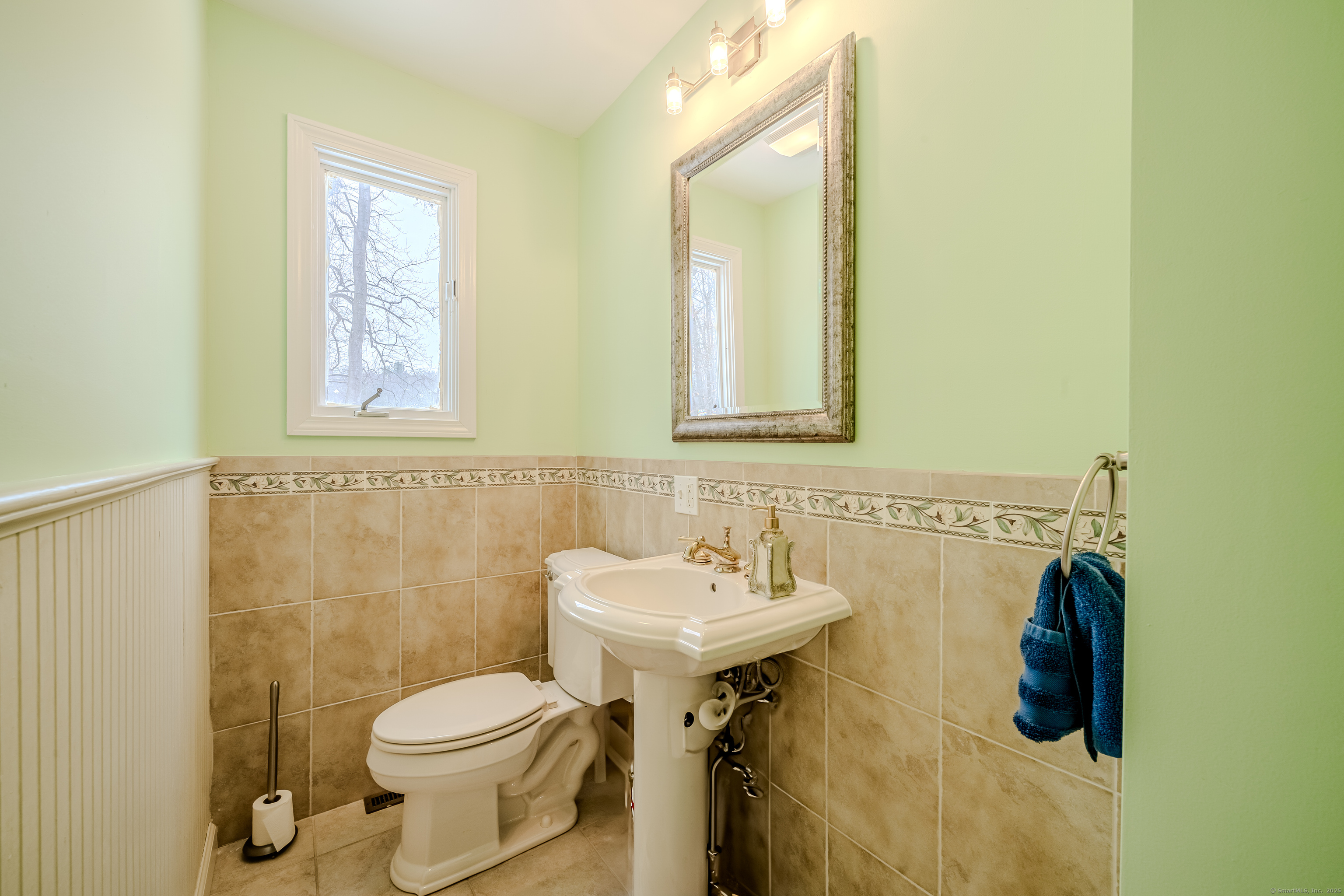 305 Rimmon Road Woodbridge, CT 06525 - Photo 13 of 28 a bathroom with a sink mirror and toilet