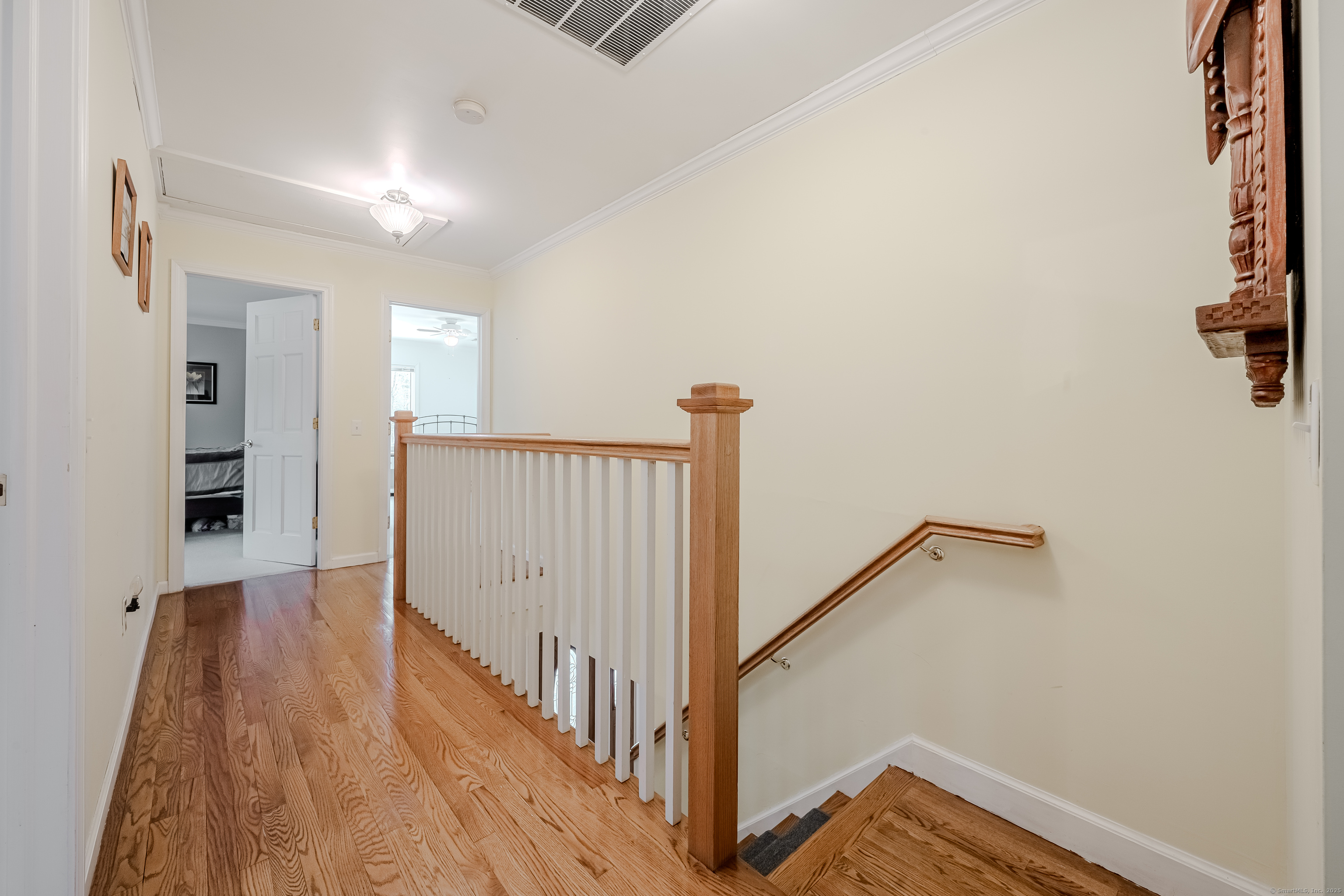 305 Rimmon Road Woodbridge, CT 06525 - Photo 15 of 28 a view of a hallway with wooden floor and staircase
