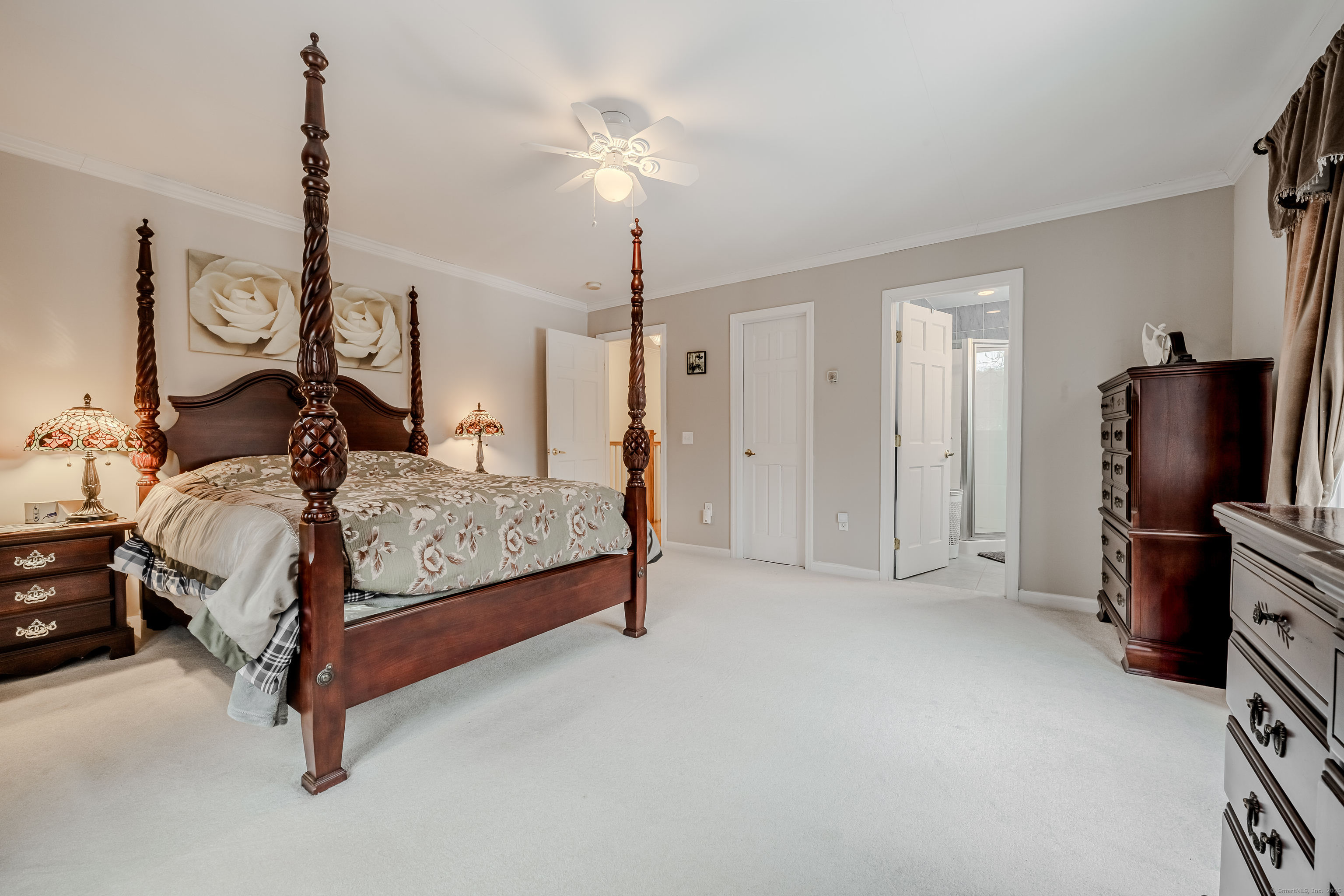 305 Rimmon Road Woodbridge, CT 06525 - Photo 17 of 28 a bedroom with a bed and a chandelier