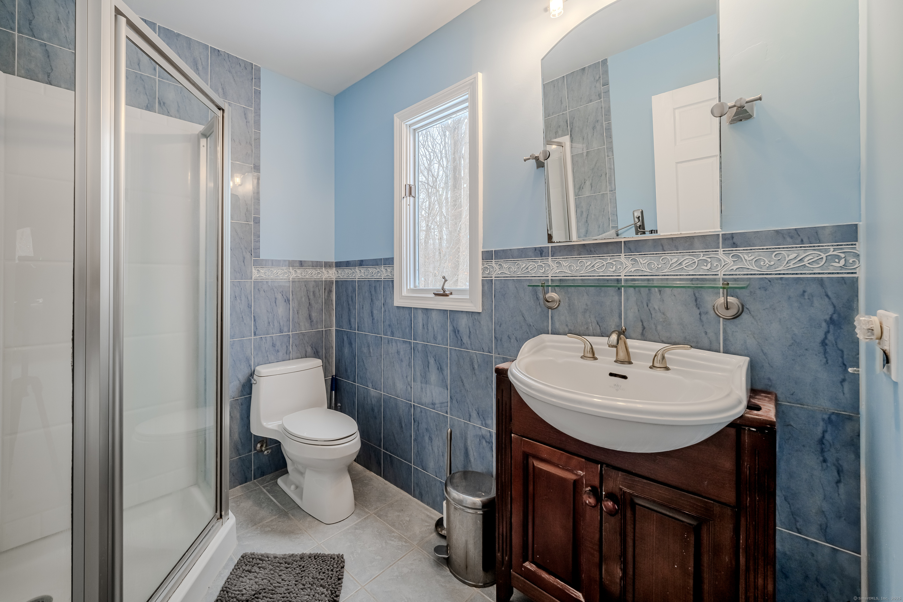 305 Rimmon Road Woodbridge, CT 06525 - Photo 18 of 28 a bathroom with a sink a toilet and a mirror