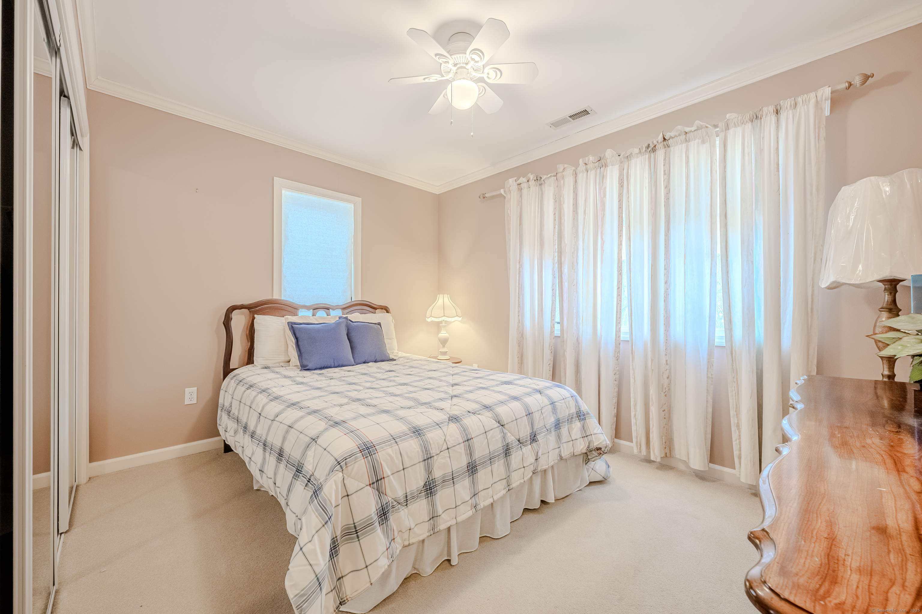 305 Rimmon Road Woodbridge, CT 06525 - Photo 19 of 28 a bedroom with a bed and a chandelier