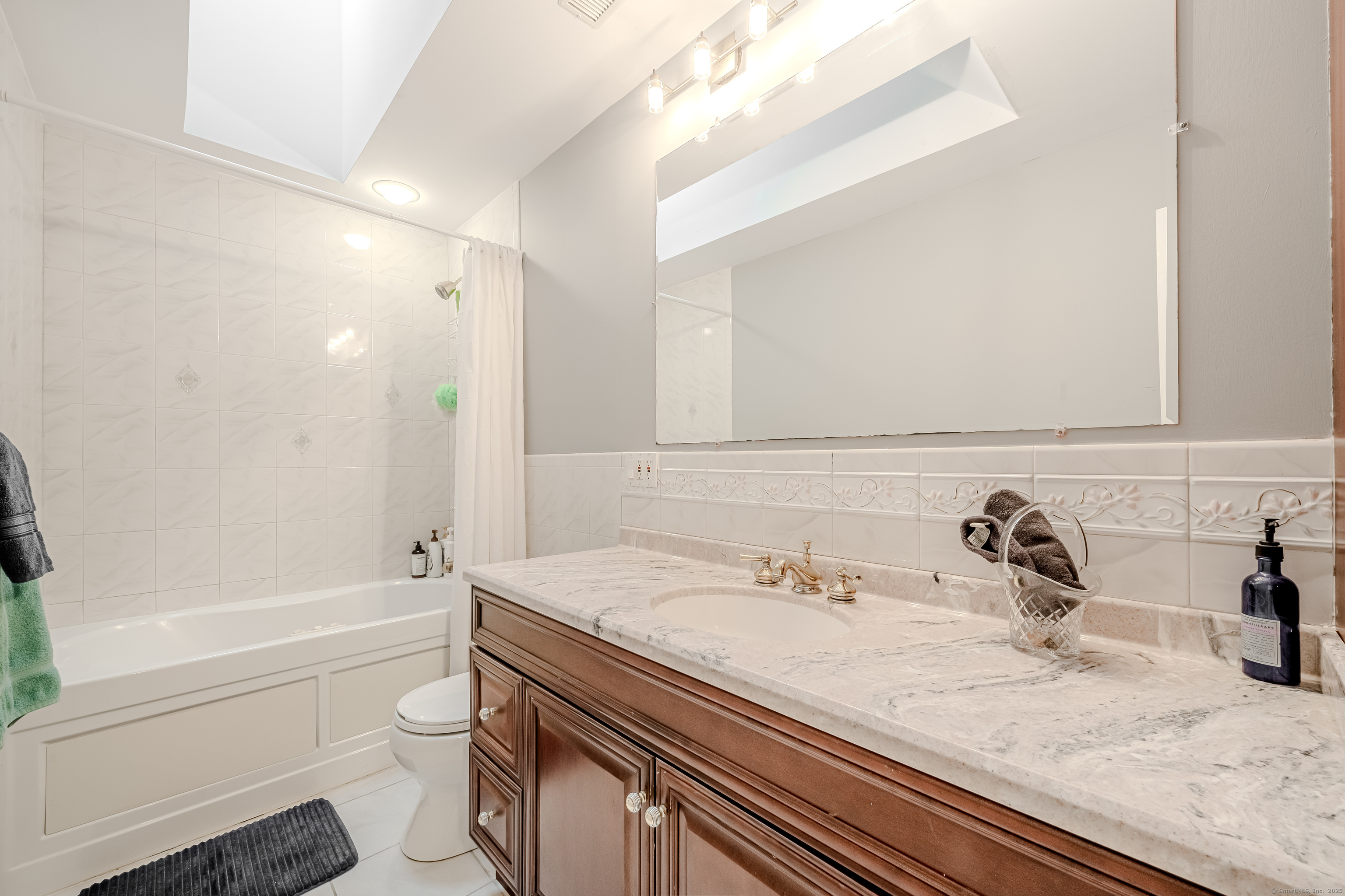 305 Rimmon Road Woodbridge, CT 06525 - Photo 20 of 28 a bathroom with a granite countertop sink toilet and shower