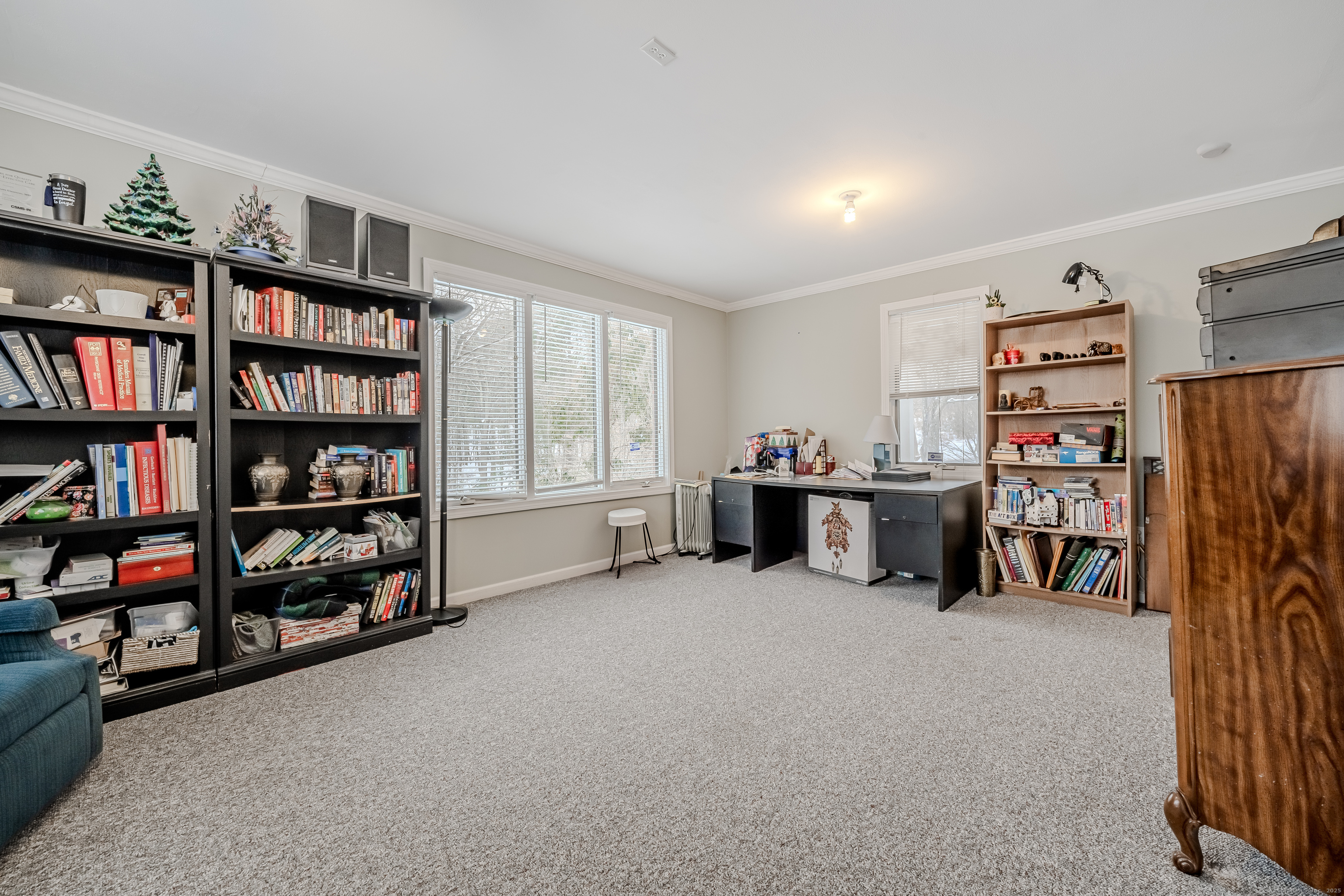 305 Rimmon Road Woodbridge, CT 06525 - Photo 23 of 28 a room with furniture and a book shelf