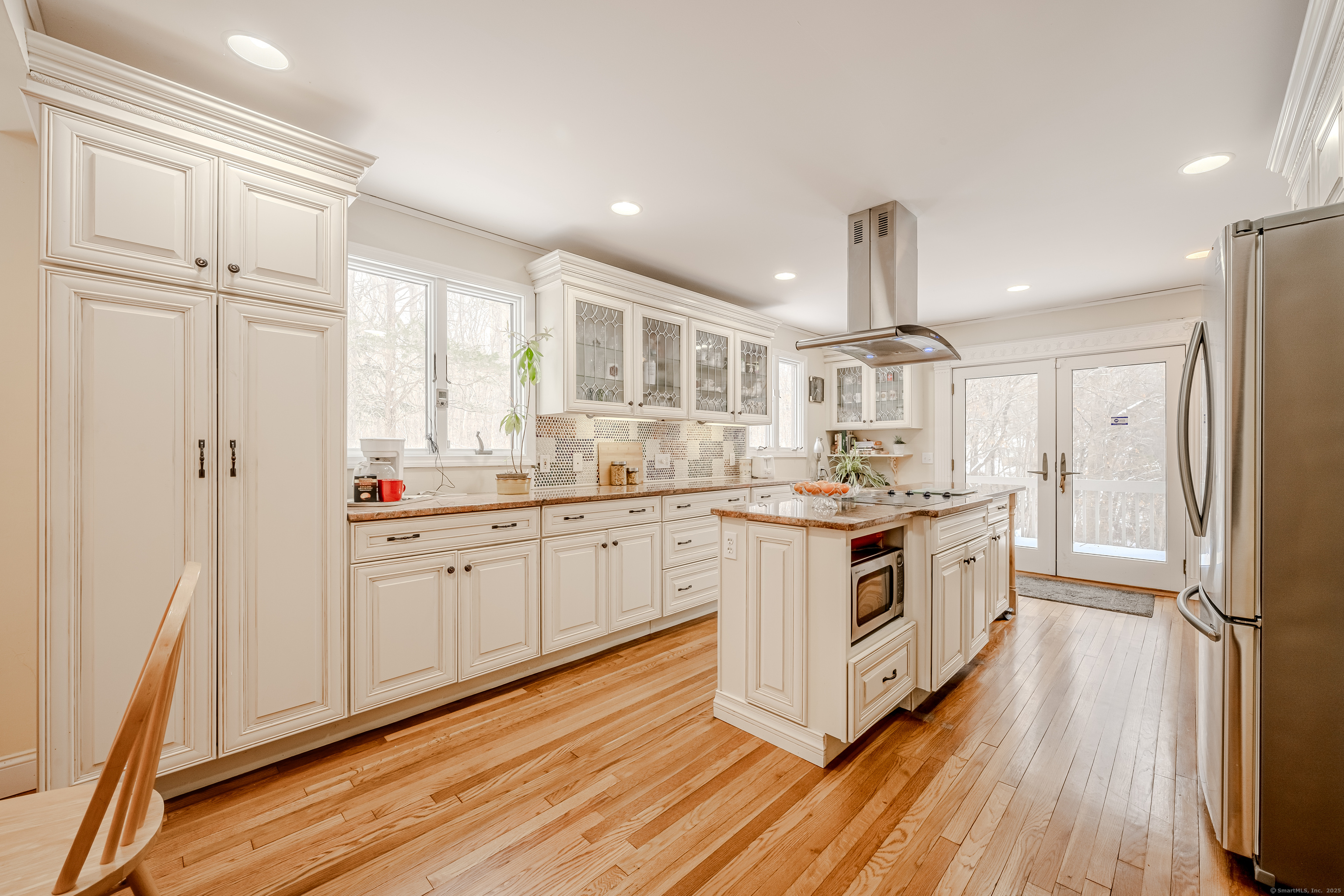 305 Rimmon Road Woodbridge, CT 06525 - Photo 6 of 28 a kitchen with white cabinets and white appliances