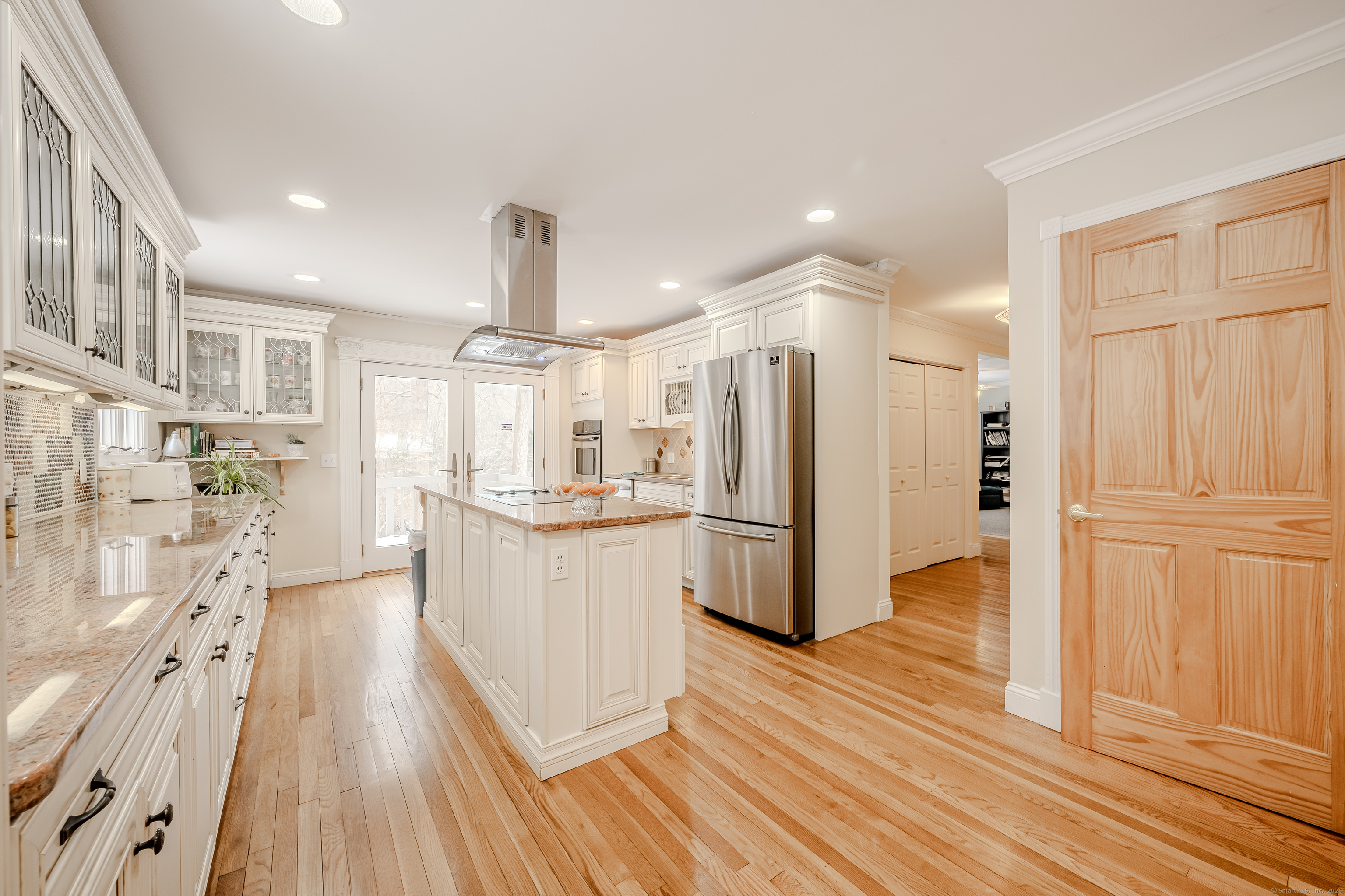 305 Rimmon Road Woodbridge, CT 06525 - Photo 7 of 28 a kitchen with stainless steel appliances a refrigerator and wooden floor