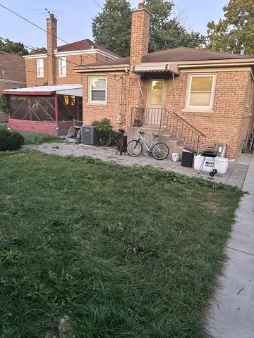 a front view of a house with patio yard and outdoor seating