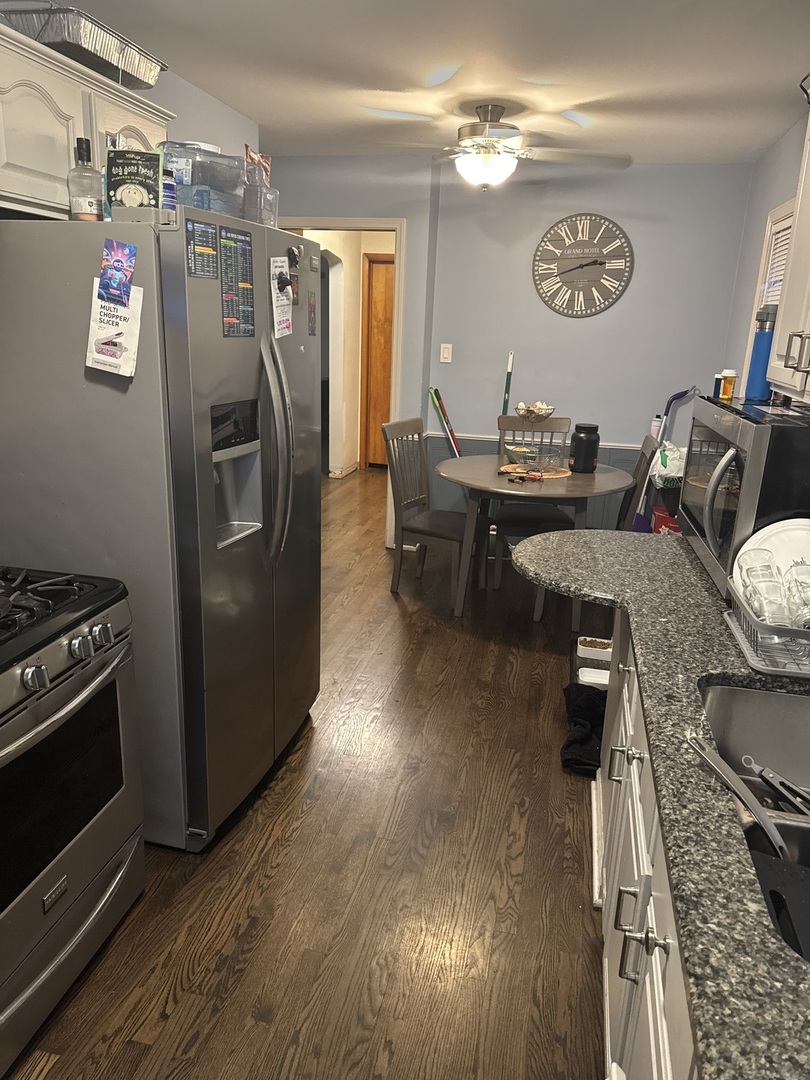 3314 South 58th Avenue Cicero, IL 60804 - Photo 8 of 13 a kitchen with stainless steel appliances granite countertop a refrigerator and a stove top oven